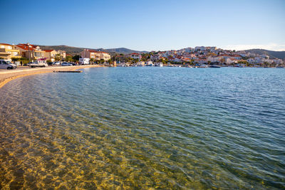 Town by sea against clear sky