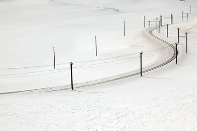 Railroad track on snow covered field