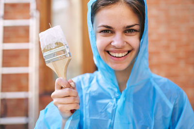 Portrait of young woman holding ice cream