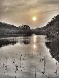 Scenic view of lake against sky during sunset