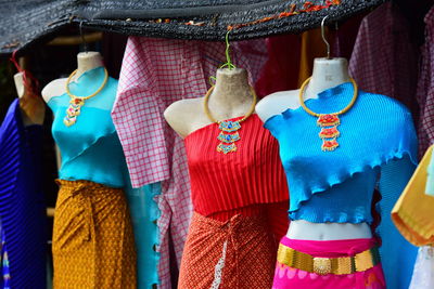 Multi colored umbrellas hanging for sale at market stall