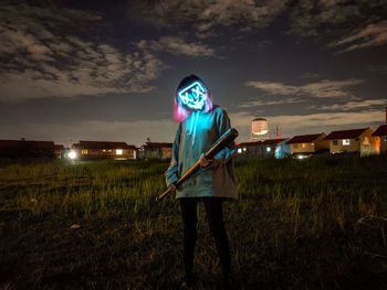 Man standing on field at night