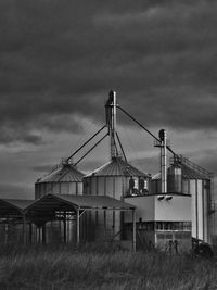 Metallic structure on field against sky