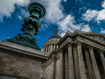 Low angle view of statue of building against cloudy sky