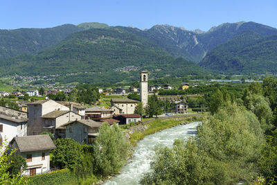 Scenic view of buildings and mountains against sky