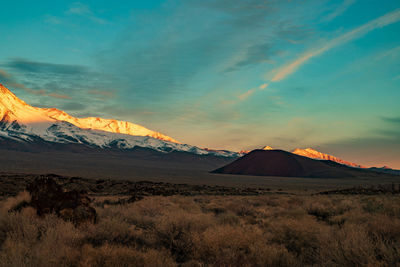 Scenic view of snowcapped mountains against sky during sunset