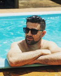 Man wearing sunglasses in swimming pool