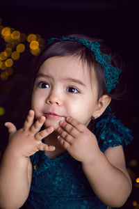 Girl in blue dress in studio with gold sequins and garland