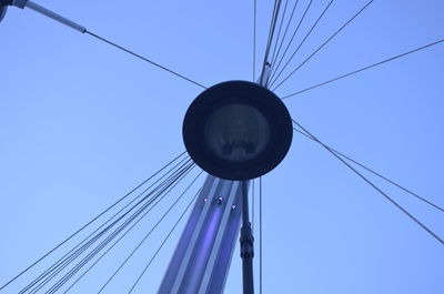 Low angle view of telephone pole against clear blue sky