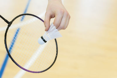 Cropped hand playing badminton