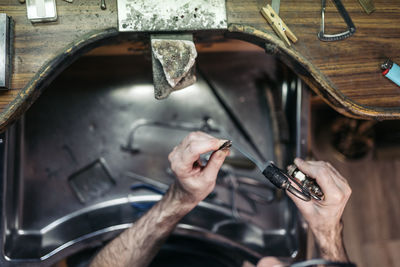 Midsection of man working in workshop