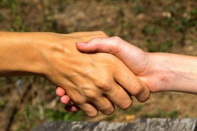 Close-up of woman hand holding hands