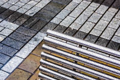 High angle view of bench on footpath