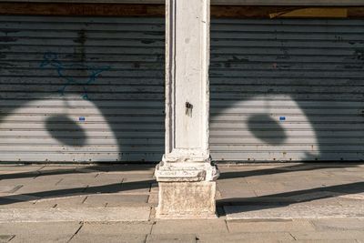 Shadow of wall with closed shutter