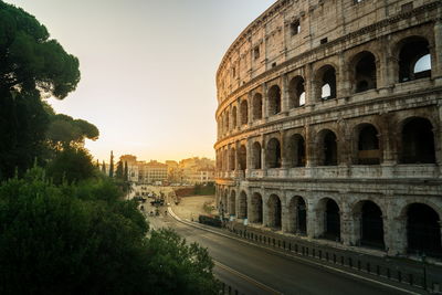 Coliseum against sky during sunset