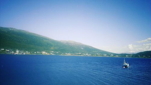 Scenic view of sea with mountains in background