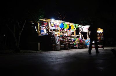 People in illuminated city at night