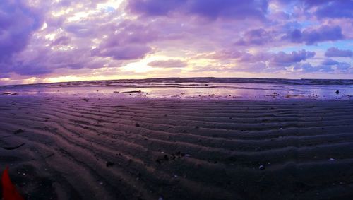 Scenic view of beach against sky during sunset