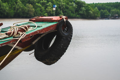 Close-up of boat moored on river