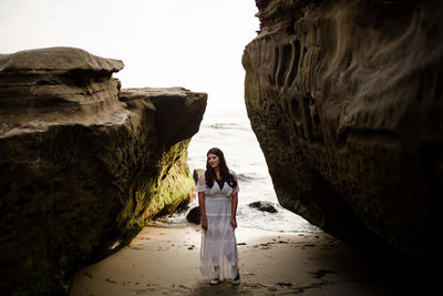 Portrait of woman standing on rock