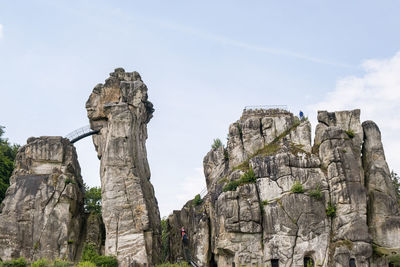 Low angle view of rock formation against sky