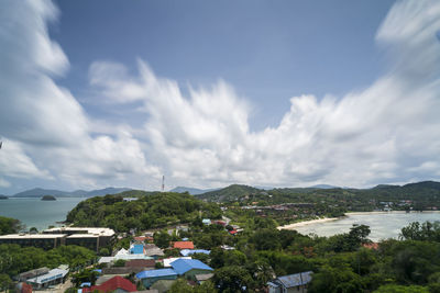 Panoramic view of buildings in town against sky