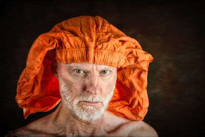 Portrait of man against orange background