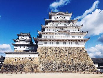 Low angle view of himeji castle against blue sky