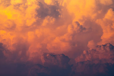 Yellow, orange fluffy clouds on sunset sky background. art picture of orange clouds texture. 