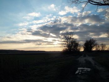 Scenic view of field against sky at sunset