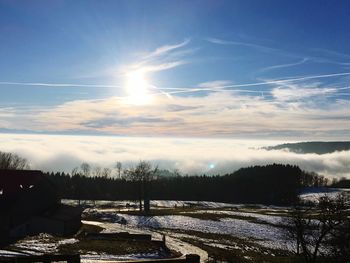 Scenic view of landscape against sky during winter