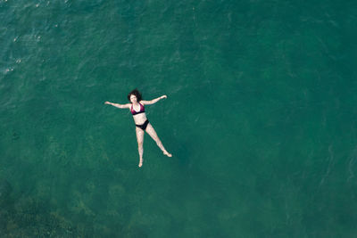 High angle view of woman swimming in sea