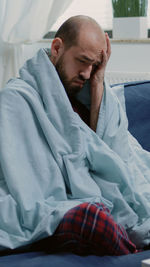 Young man sleeping on bed