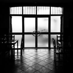 Empty room against sky seen through window