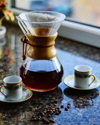 Close-up of coffee with cups on table