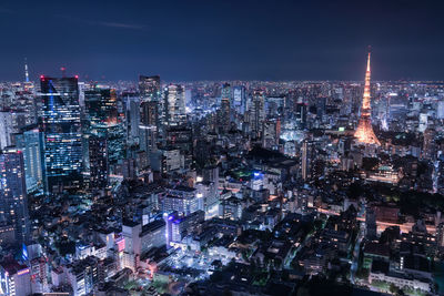 Illuminated cityscape against sky at night