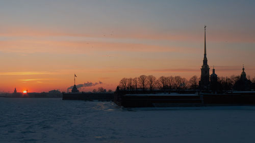 Scenic view of silhouette building against sky during sunset