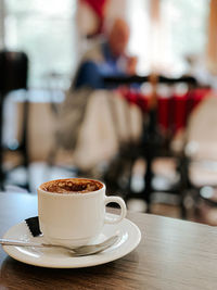 Close-up of coffee served on table at cafe