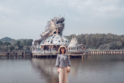 Portrait of woman standing against sky