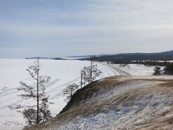 Scenic view of snow covered land against sky