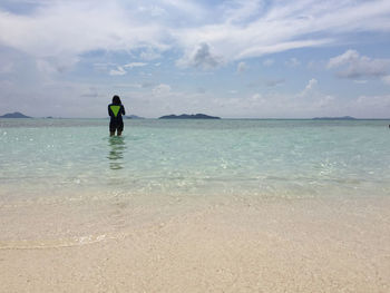Full length of man on beach against sky