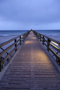 Pier over sea against sky