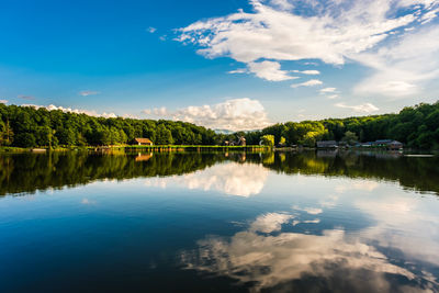 Clouds in the blue sky reflecting in the lake, sibiu, romania