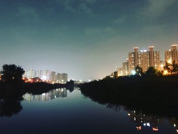 Reflection of illuminated buildings in calm water at night