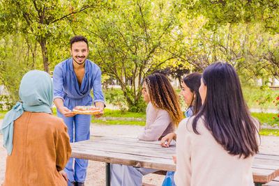 Cheerful friends sitting outdoors