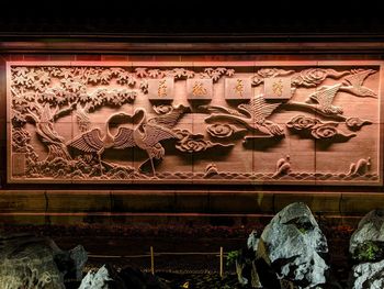 Low angle view of sculpture on house window