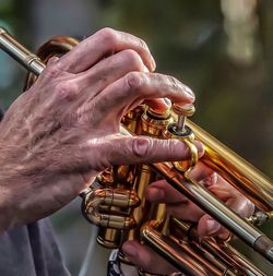 Cropped hand of man playing trumpet