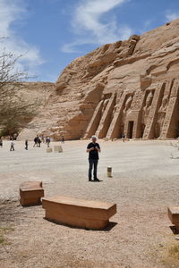 Man standing against old ruins