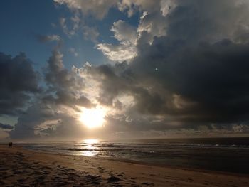 Scenic view of beach against sky during sunset