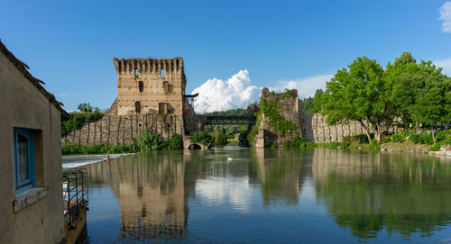 Ponte visconteo  - reflection of building in borghetto - valeggio sul mincio, verona - italy